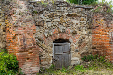 Fototapeta na wymiar An old cellar of bricks and stones on the territory of the estate Gorodnya (Galician nobles) near Kaluga. Ferzikovsky District, Kaluzhskiy region, Russia - July 2019