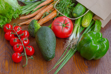 Healthy food in full paper bag of different products, vegetables. Top view. Food background.