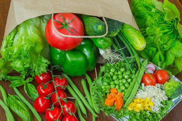 Healthy food in full paper bag of different products, vegetables. Top view. Food background.