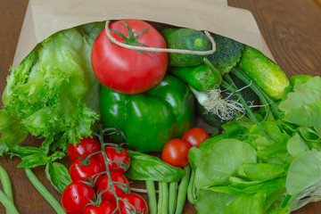 Healthy food in full paper bag of different products, vegetables. Top view. Food background.