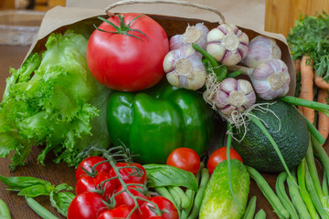 Healthy food in full paper bag of different products, vegetables. Top view. Food background.