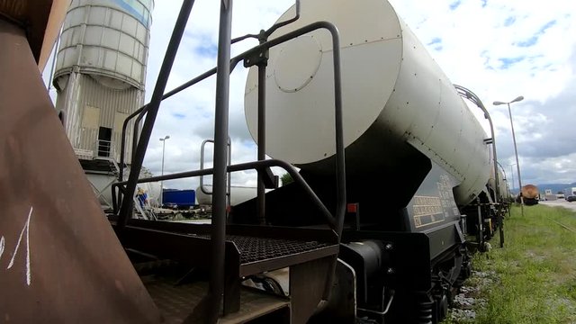 Wagons for liquids waits for further transportation on train depot moving forward