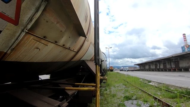 Wagons for liquids waits for further transportation on train depot moving forward