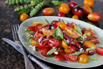 cherry tomato salad with basil and red onion, large sea salt and olive oil