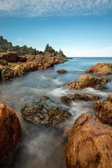 Seascape with silky waves washing over the rugged rocky coast. Atlantic coast of Newfoundland.  