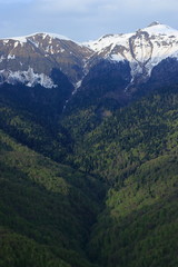 Fototapeta na wymiar Snow-capped peaks of the Caucasus Mountains