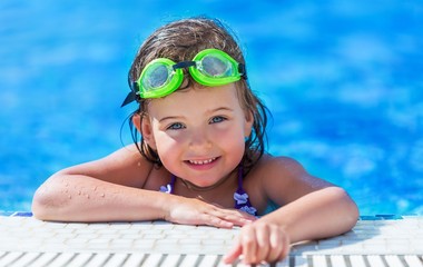 a girl swimming in a small pool