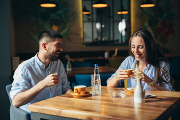 A happy young couple on a date at a fancy restaurant