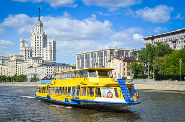 Pleasure boat on Moscow river. Stalin's High-rise on Kotelnicheskaya embankment.