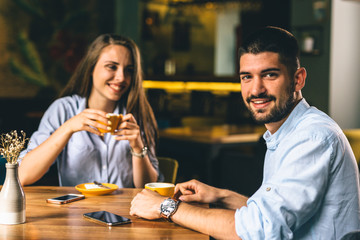 man enjoying her time with his girlfriend at a cafe