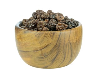 Dried raisins sultanas in a dark wooden bowl on a white background