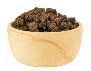 Dried raisins sultanas in a light wooden bowl on a white background