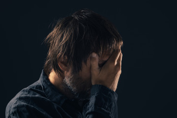 Depressed sad mid-adult man portrait