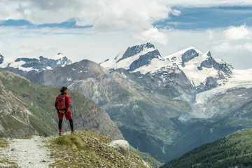 young woman, hiking on the moraine above Zmutt glacier near Zermatt, Cantone Valais, Wallis, Switzerland