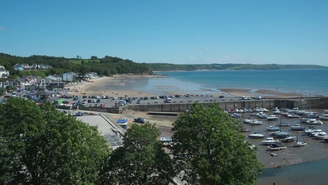 Panning overview of boats and harbour at Saundersfoot Pembrokeshire Wales   