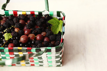 fresh blackberries and gooseberry in the wicker basket