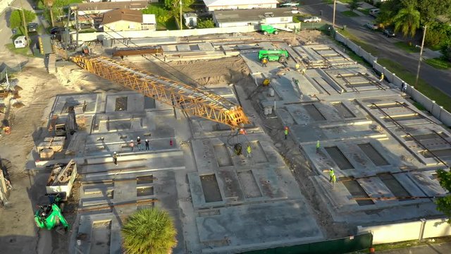 Men setting a crane at construction site project