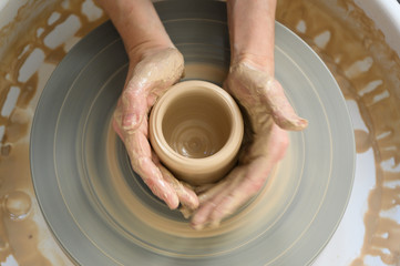 Above view of process of making clay pot on potter's wheel