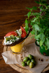 Bruschetta with cheese and olives on a wooden table
