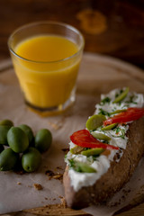 Bruschetta with cheese and olives on a wooden table