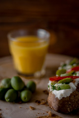 Bruschetta with cheese and olives on a wooden table