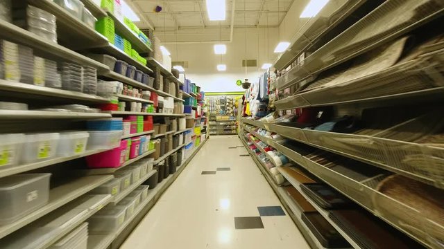 At the supermarket store pov action camera motion, through row section of the shop and different items merchandise. Front view shot. 4k.