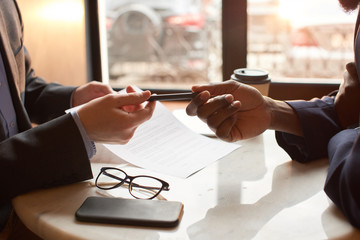 Two businessmen have a construction contract for a business lunch