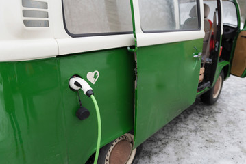 Electric van is being charged in winter landscape, Kuopio, Finland