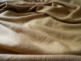 Fototapeta premium Messy yellow blanket with texture 