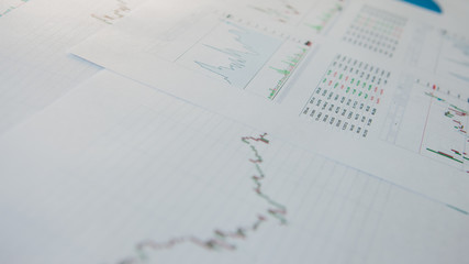 Investment in securities, concept. Financial reports, tables and graphs.