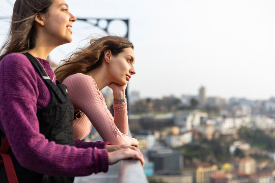 Two young women looking at view, Porto, Portugal