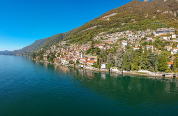Aerial view landscape on beatiful Lake Como in Carate Urio, Lombardy, Italy. Scenic small town with traditional houses and clear blue water. Summer tourist vacation on rich resort with nice harbour