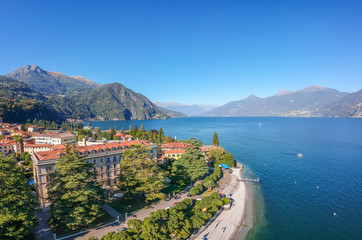 Aerial view landscape on beatiful Lake Como in Menaggio, Lombardy, Italy. Scenic small town with traditional houses and clear blue water. Summer vacation for tourists on rich resort with nice harbour
