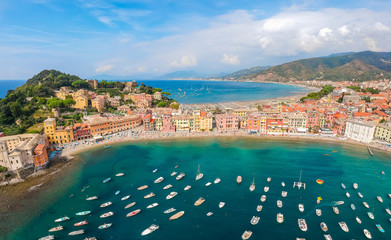 Sea aerial landscape in Sestri Levante, Liguria, Italy. Scenic fishing village with traditional houses and clear blue water. Summer vacation rich resort with picturesque harbour and nice sand beach