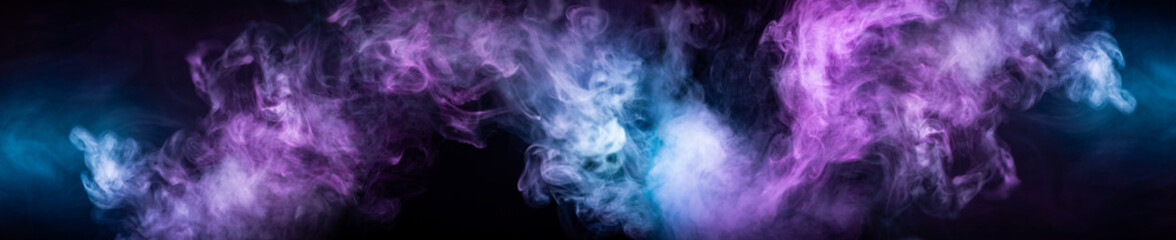 Abstract colorful smoke on black background .