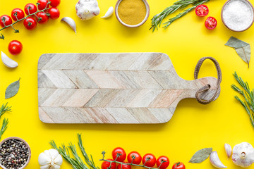 Products frame and cutting board on yellow background top view mockup