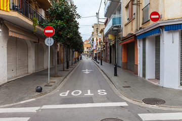 Street in Calella in Catalonia, Spain near Barcelona. Scenic old town with sand beach and clear blue water. Famous tourist destination in Costa Brava, perfect place for holiday and vacation