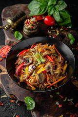 Soba, udon, asian wheat noodles with beef and vegetables: broccoli, carrots, sweet peppers, zucchini