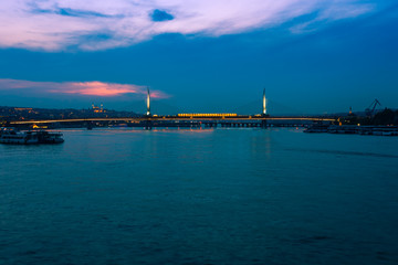 Obraz premium Night view of Istanbul. Panorama cityscape of famous tourist destination Golden Horn bay part of Bosphorus strait. Travel illuminated landscape Bosporus, Turkey, Europe and Asia.