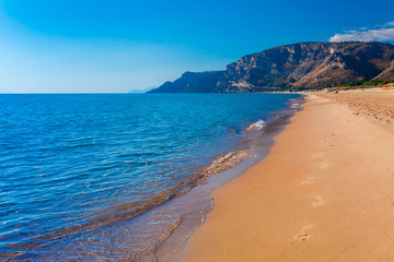 Fototapeta na wymiar Panoramic sea beach landscape near Gaeta, Lazio, Italy. Nice sand beach and clear blue water. Famous tourist destination in Riviera de Ulisse. Bright sunny light and sunset.