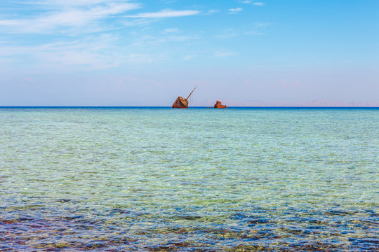 Red Sea coast, reef and wrecked ship in the Nabq National Park. Famous travel destionation in desert. Sharm el Sheik, Sinai Peninsula, Egypt.