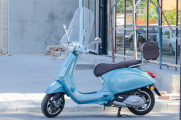  Blue scooter, parked in the street 