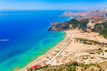 Sea skyview landscape photo Tsambika bay on Rhodes island, Dodecanese, Greece. Panorama with nice sand beach and clear blue water. Tsampika is a famous tourist destination in South Europe