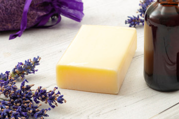 Aromatherapy spa and natural hygiene products concept with homemade soap surrounded by violet pouch...