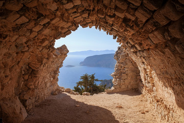 Sea skyview landscape photo from ruins of Monolithos castle on Rhodes island, Dodecanese, Greece. Panorama with green mountains and clear blue water. Famous tourist destination in South Europe