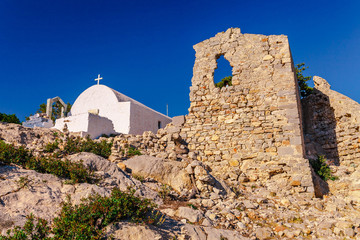 Sea skyview landscape photo from ruins of Monolithos castle on Rhodes island, Dodecanese, Greece. Panorama with green mountains and clear blue water. Famous tourist destination in South Europe