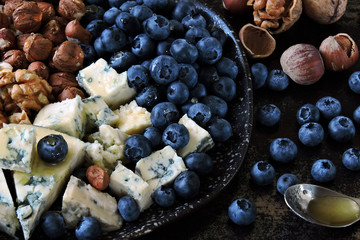 Plate with blue cheese, blueberries and nuts. Keto diet. Keto snack.