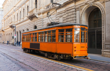 Naklejka na ściany i meble Old vintage tram in the city centre of the Milan, Lombardia, Italy. Famous tourist destination in South Europe