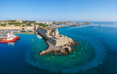 Naklejka na ściany i meble Aerial birds eye view drone photo of Rhodes city island, Dodecanese, Greece. Panorama with Mandraki port, lagoon and clear blue water. Famous tourist destination in South Europe