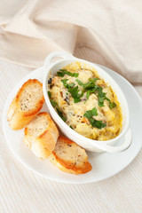 Cod casserole with mussels, creamy gravy, parmesan cheese and provencal herbs, served with french baguette and garlic oil